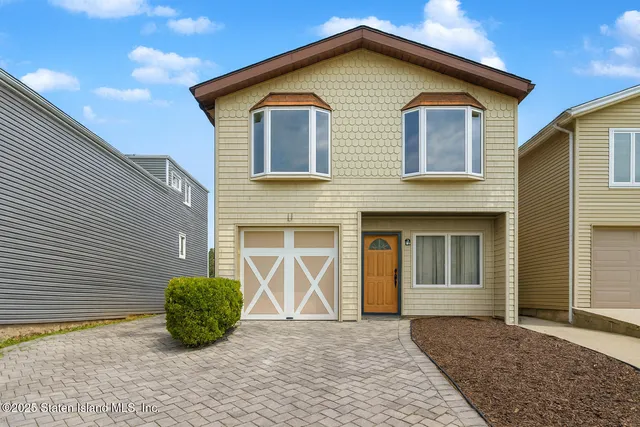 a view of house with backyard