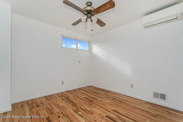 a view of a room with a ceiling fan
