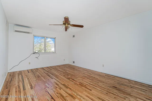 a view of a room with wooden floor closet and windows
