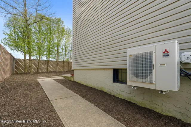 a view of a house with a yard and wooden floor and fence