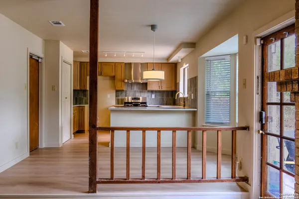 a open kitchen with stainless steel appliances granite countertop a refrigerator and a sink