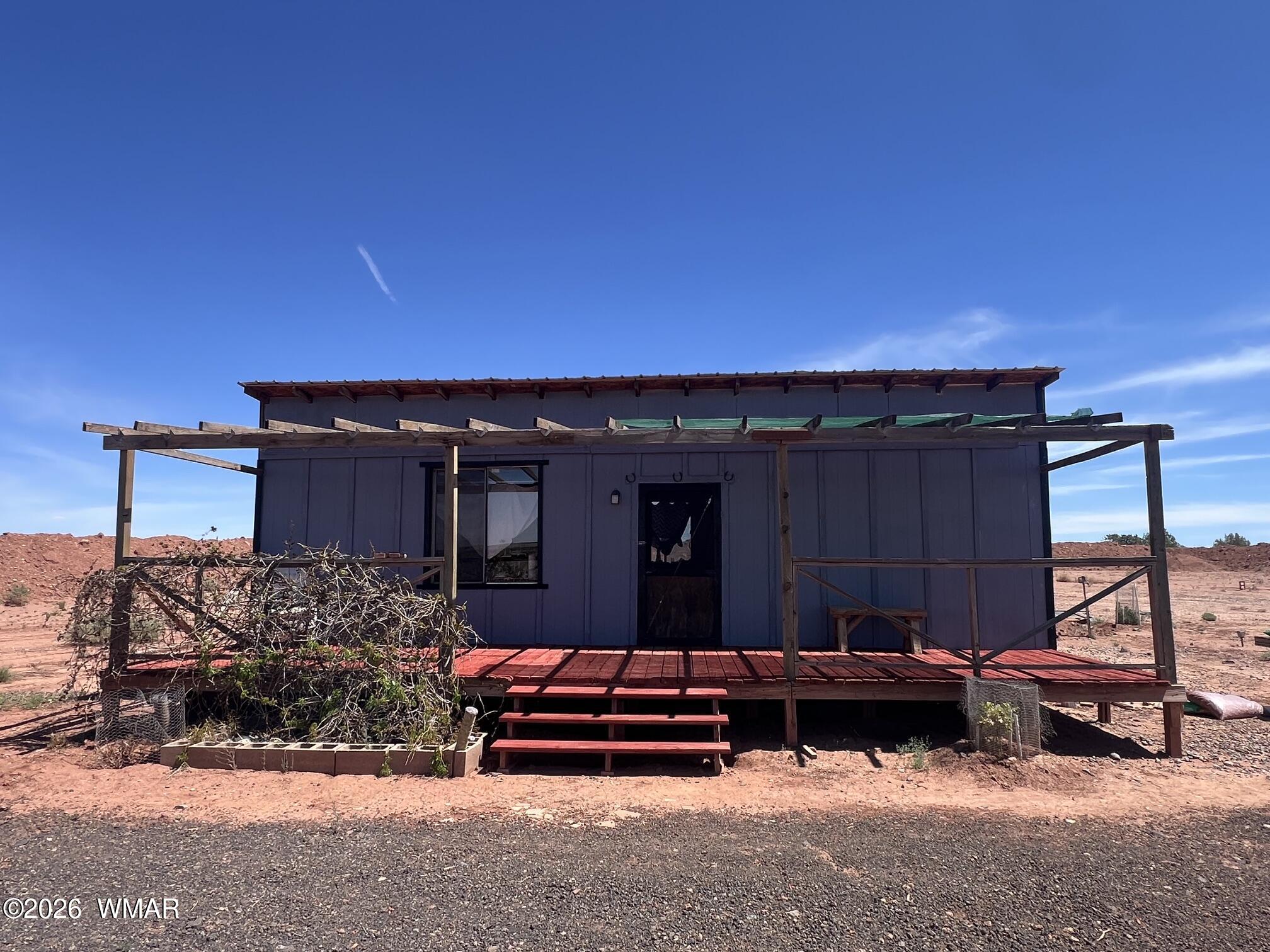 a view of a house with a bed and wooden fence