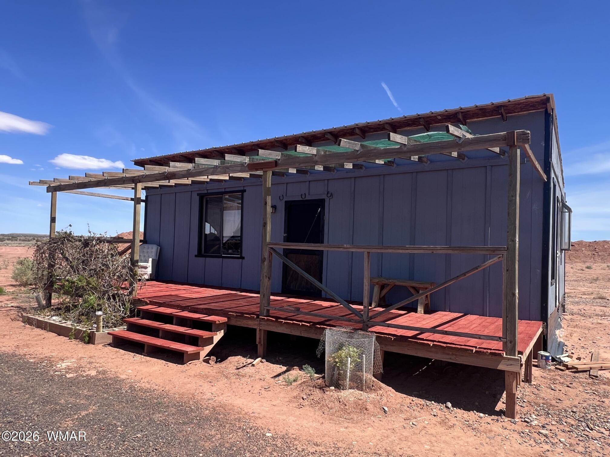 5021 Rae Trail Snowflake, AZ 85937 - Photo 2 of 23 a backyard of a house with wooden fence and a bench