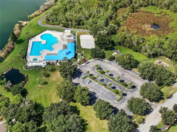 an aerial view of a house with a yard and lake view