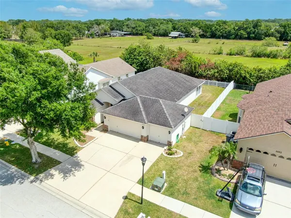 an aerial view of a house with a yard