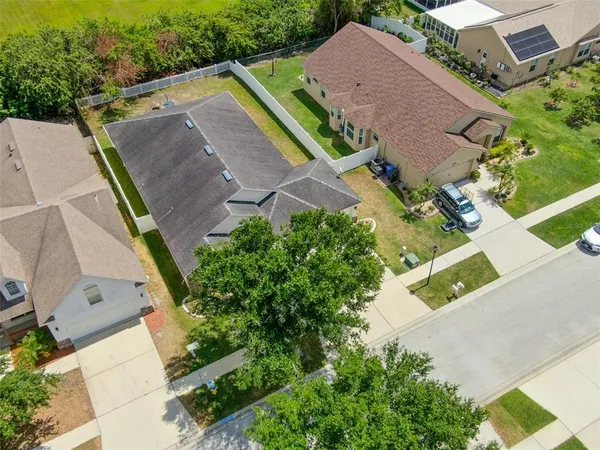 an aerial view of residential houses with outdoor space and river