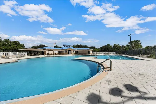 a view of outdoor space with swimming pool and green space