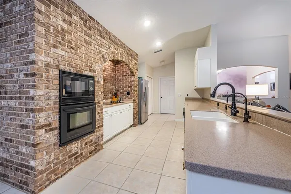 a large kitchen with a sink and stainless steel appliances