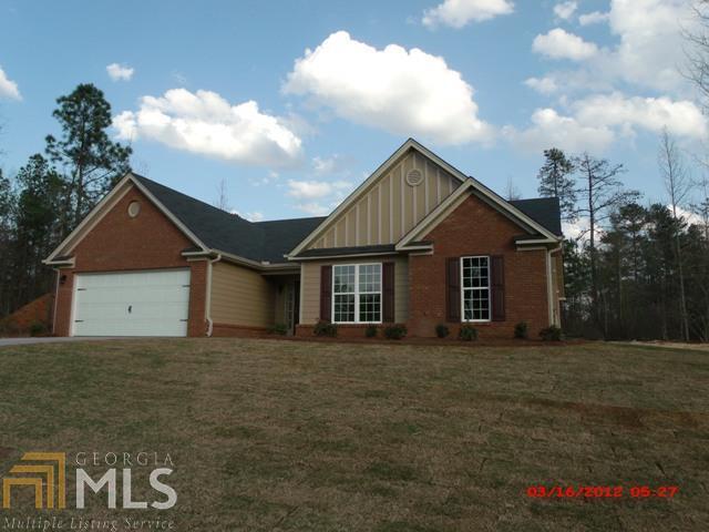 574 Morgans Ridge Court, Unit 21 Winder, GA 30680 - Photo 1 of 1 a front view of a house with a garden