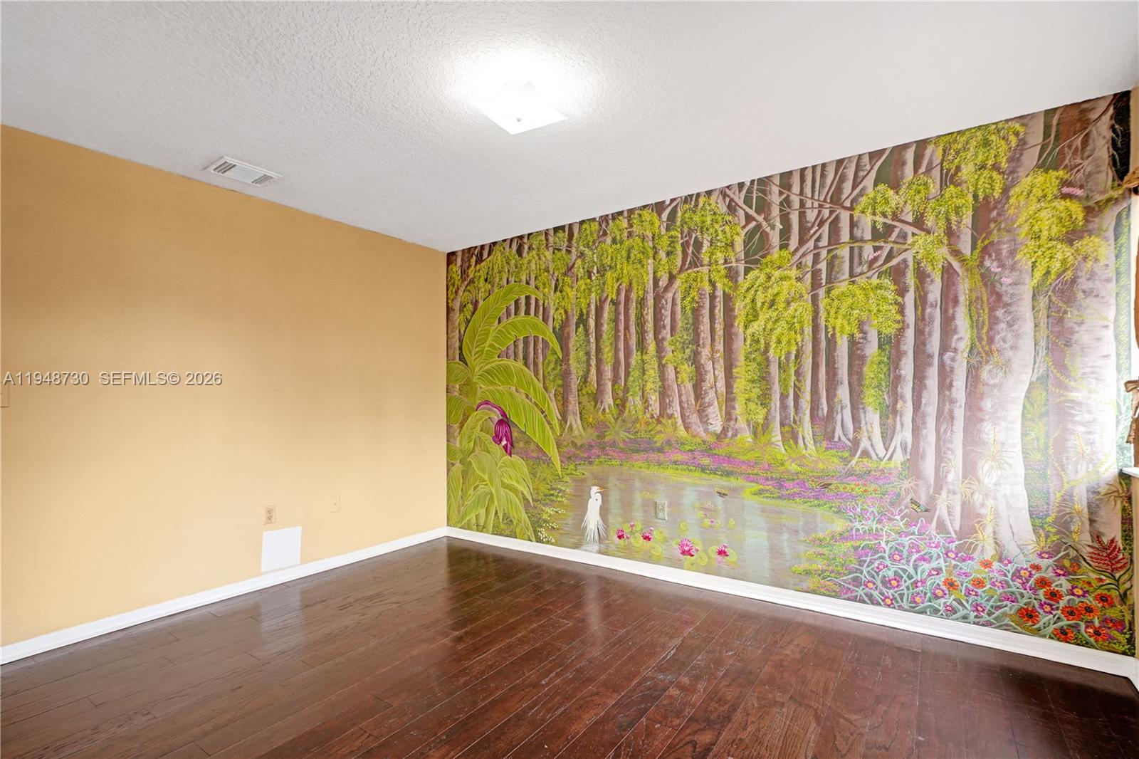 5502 Southwest 162nd Place Miami, FL 33185 - Photo 46 of 72 a view of an empty room with wooden floor and a window