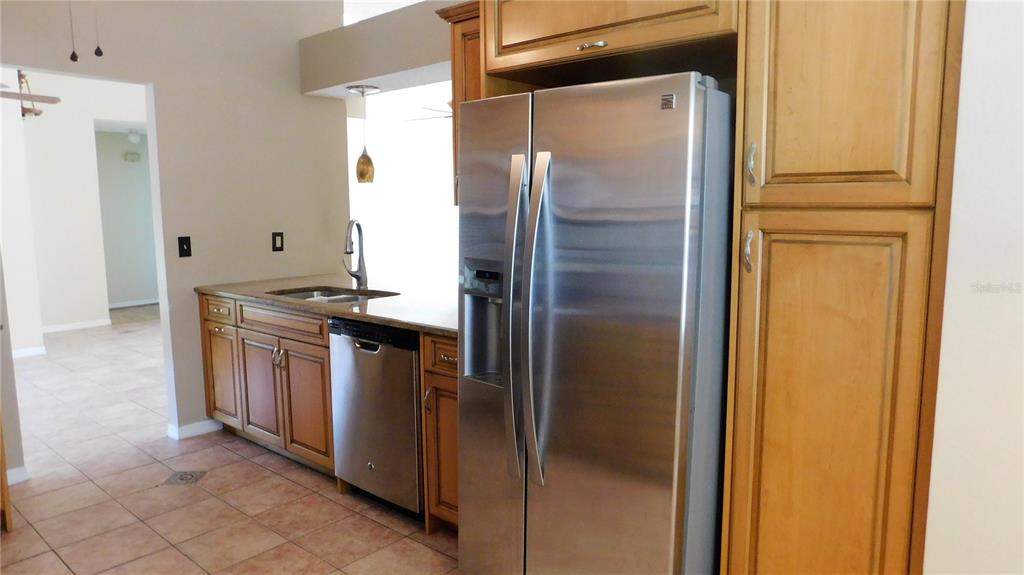9353 Vía Segovia New Port Richey, FL 34655 - Photo 11 of 25 a kitchen with a refrigerator and a sink