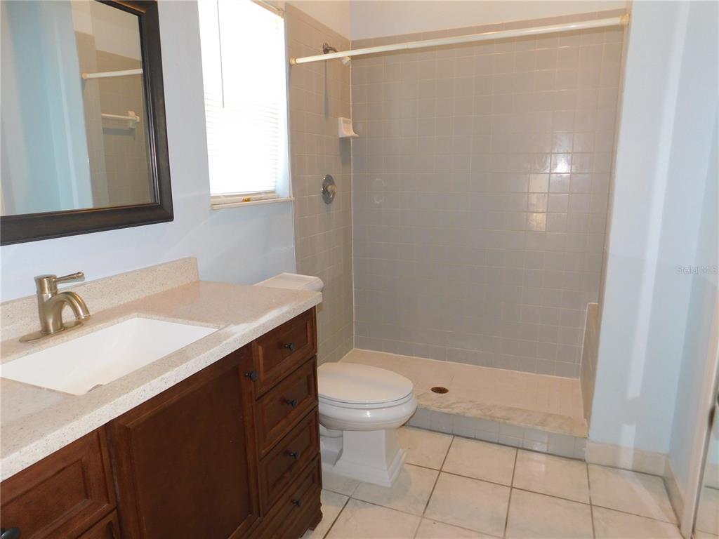 9353 Vía Segovia New Port Richey, FL 34655 - Photo 17 of 25 a bathroom with a sink a toilet and shower