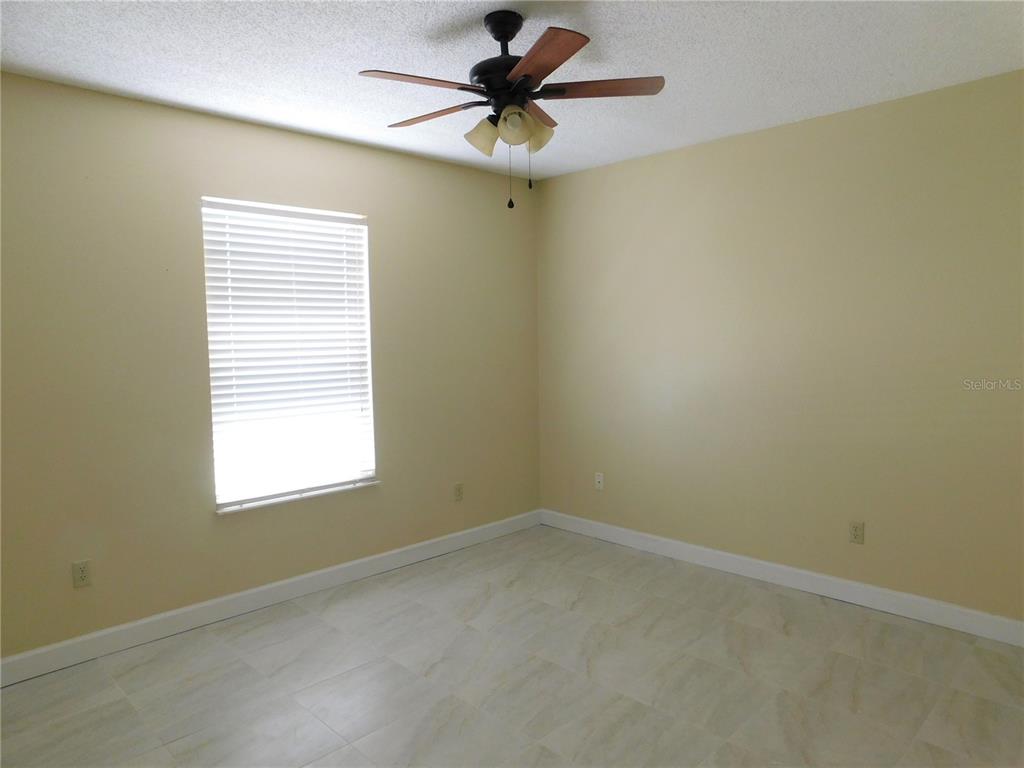 9353 Vía Segovia New Port Richey, FL 34655 - Photo 18 of 25 an empty room with a window and a fan