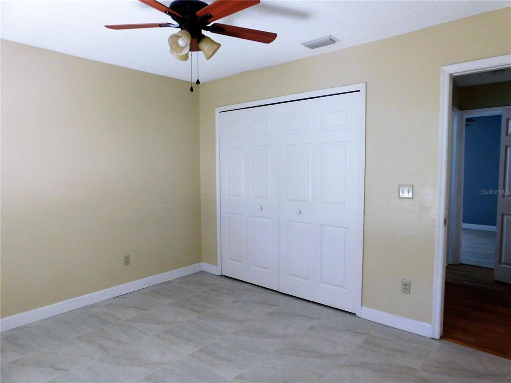 9353 Vía Segovia New Port Richey, FL 34655 - Photo 19 of 25 an empty room with closet and a chandelier fan