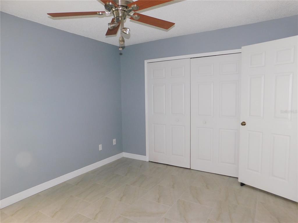 9353 Vía Segovia New Port Richey, FL 34655 - Photo 22 of 25 an empty room with a ceiling fan and a window