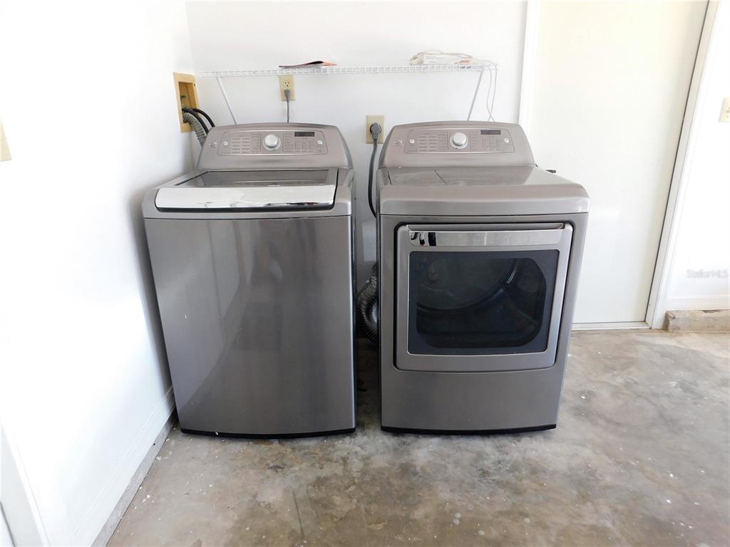 9353 Vía Segovia New Port Richey, FL 34655 - Photo 23 of 25 a utility room with dryer and washer
