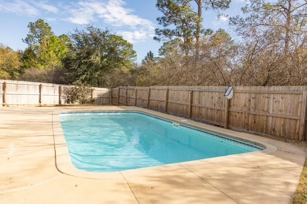 a view of a white house with swimming pool in front of it