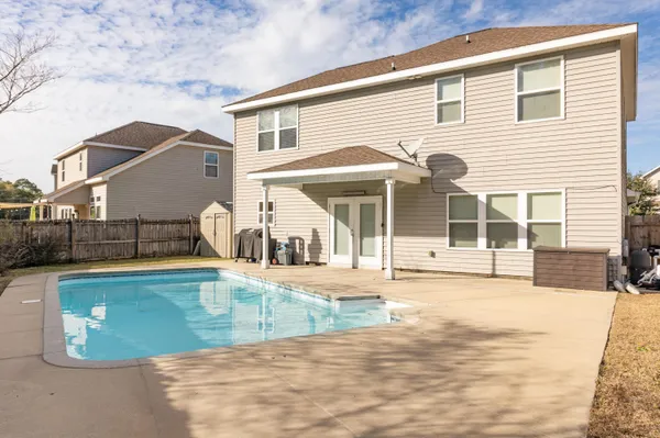 a kitchen with kitchen island granite countertop a refrigerator stove and sink