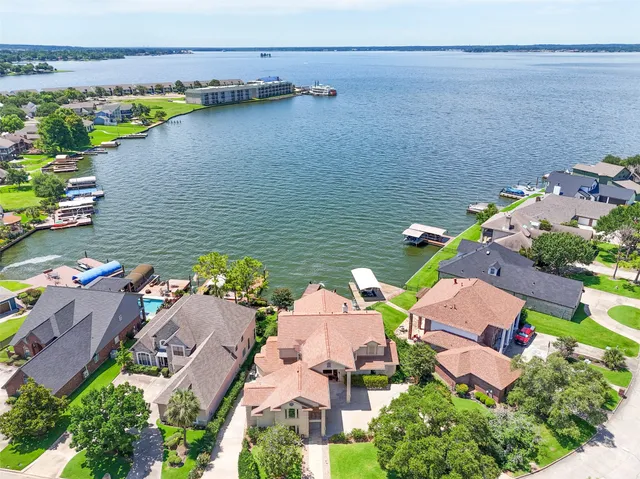 an aerial view of house with yard and ocean view