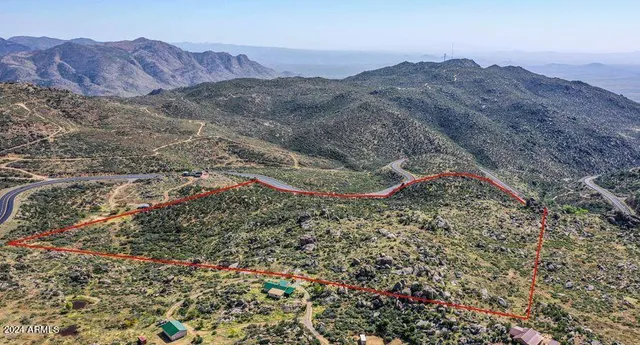 a view of a mountain range with a lush green hillside