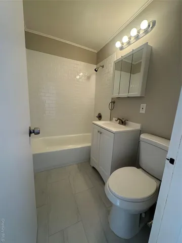 a white toilet sitting next to a bathroom sink and tub