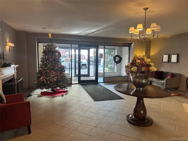 a living room with furniture and a chandelier
