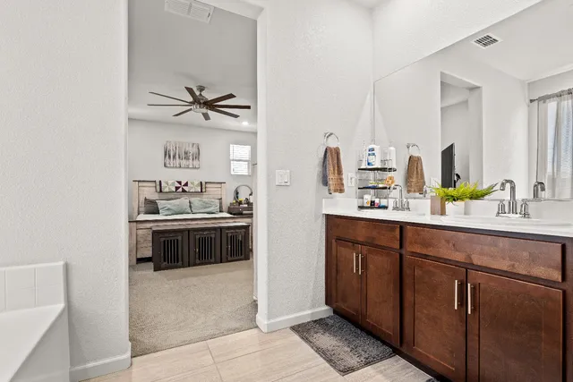 a spacious bathroom with a sink and mirror