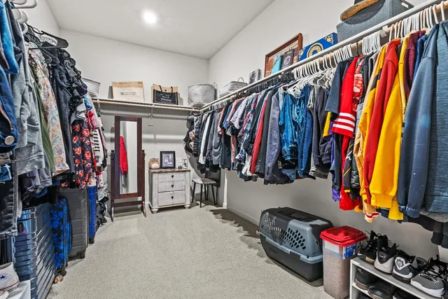 a living room with furniture kitchen view and a wooden floor