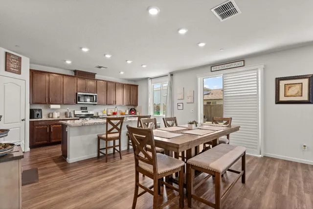 a view of a hallway with wooden floor and furniture