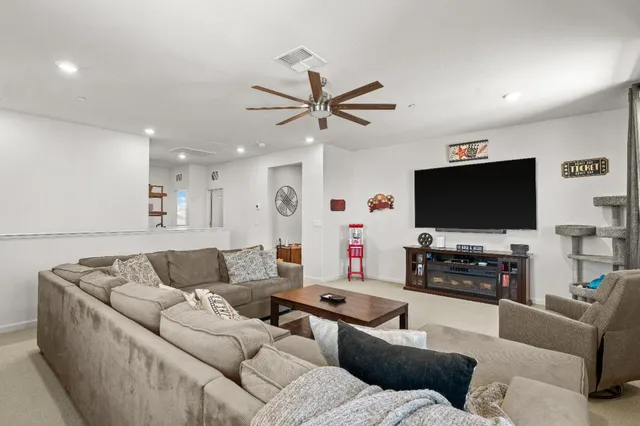 a patio with a table and chairs and potted plants