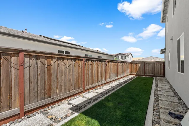 a view of a patio with a table and chairs