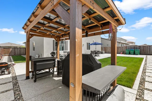 a view of a house with backyard porch and furniture