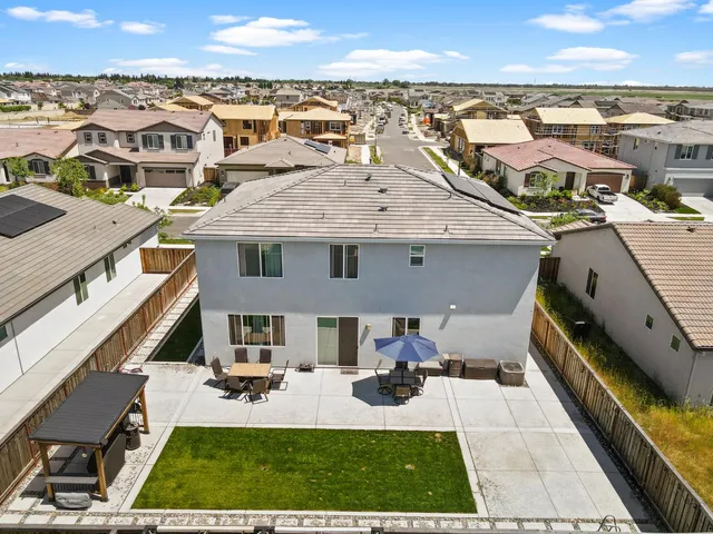 a view of a patio with a table and chairs