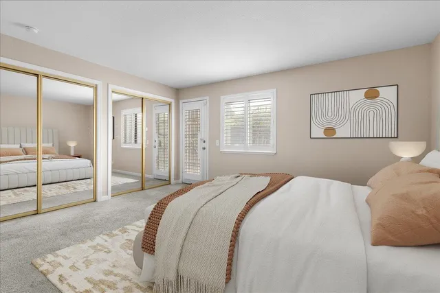 a bedroom with a large bed and a large mirror