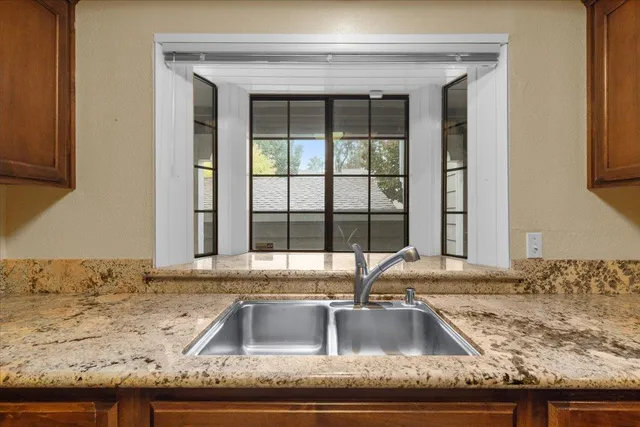 a kitchen with granite countertop a sink and a counter top space