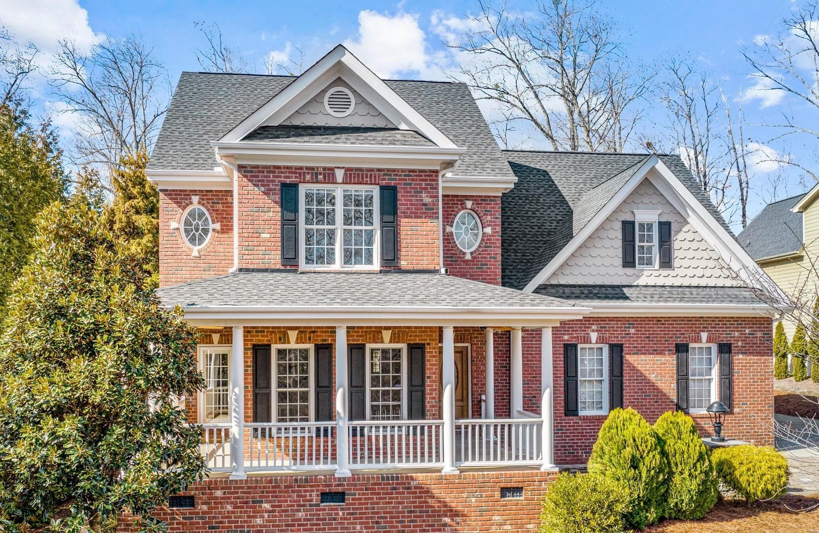 a view of a brick house with large windows