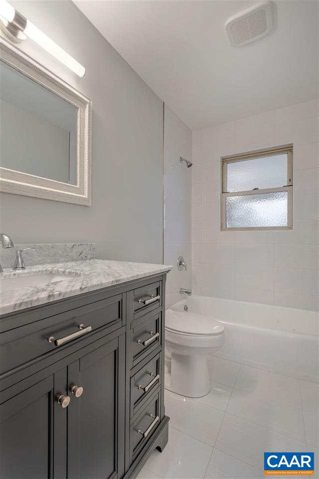 520 Stephens Loop Ruckersville, VA 22968 - Photo 17 of 33 a bathroom with a granite countertop toilet a sink a mirror and a bathtub
