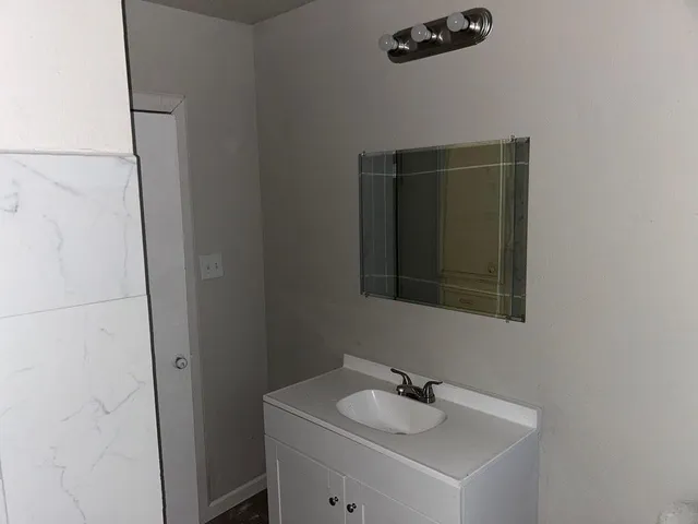 a bathroom with a sink and mirror