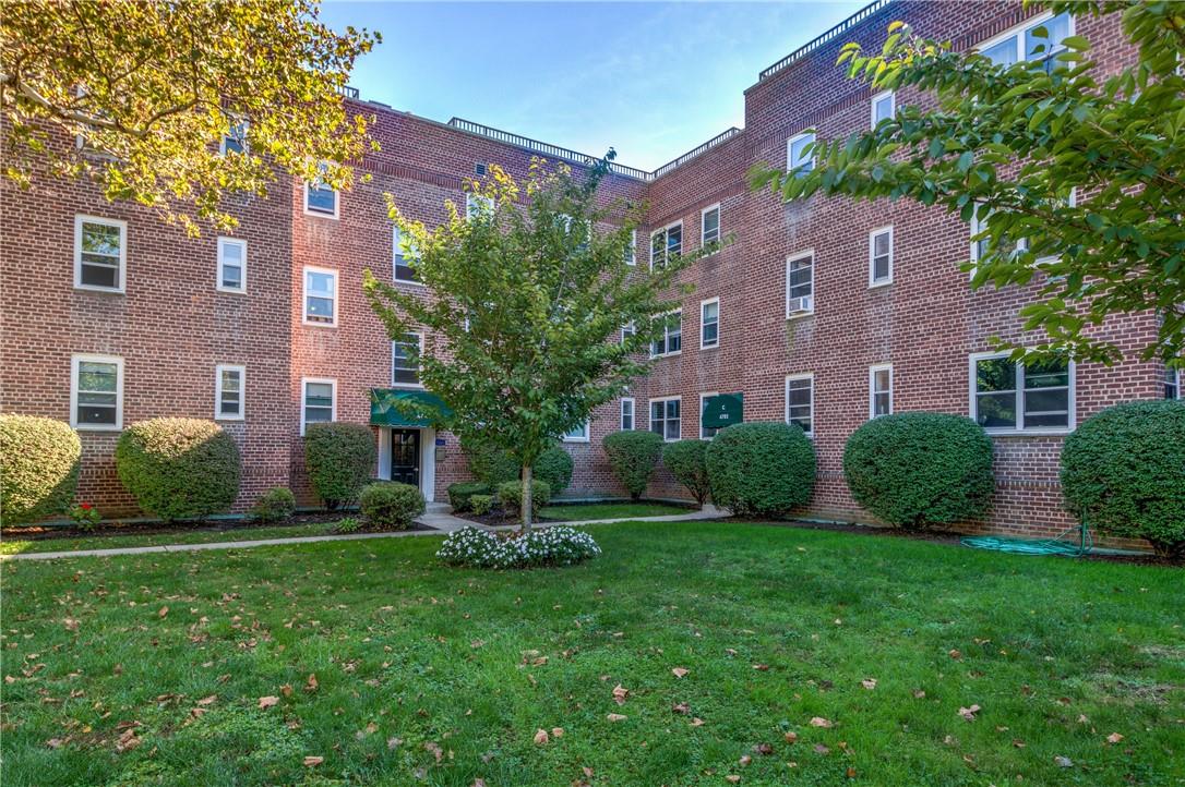 a view of a brick building next to a yard