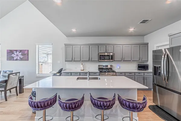 a kitchen with a dining table and chairs