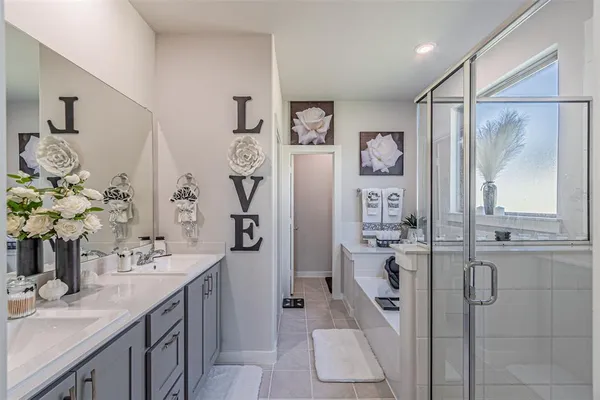 a spacious bathroom with a shower sink and mirror