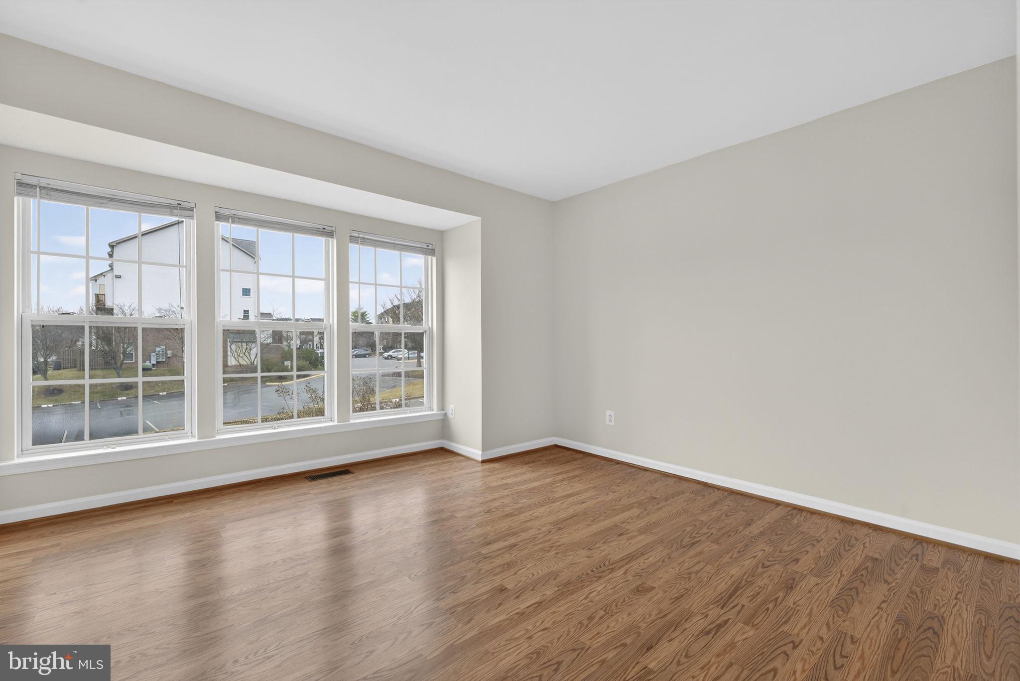 6741 Stone Maple Terrace Centreville, VA 20121 - Photo 15 of 24 a view of an empty room with wooden floor and a window