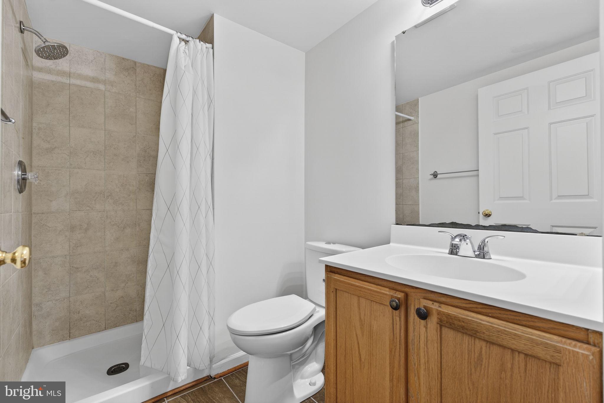 6741 Stone Maple Terrace Centreville, VA 20121 - Photo 16 of 24 a bathroom with a sink and a mirror