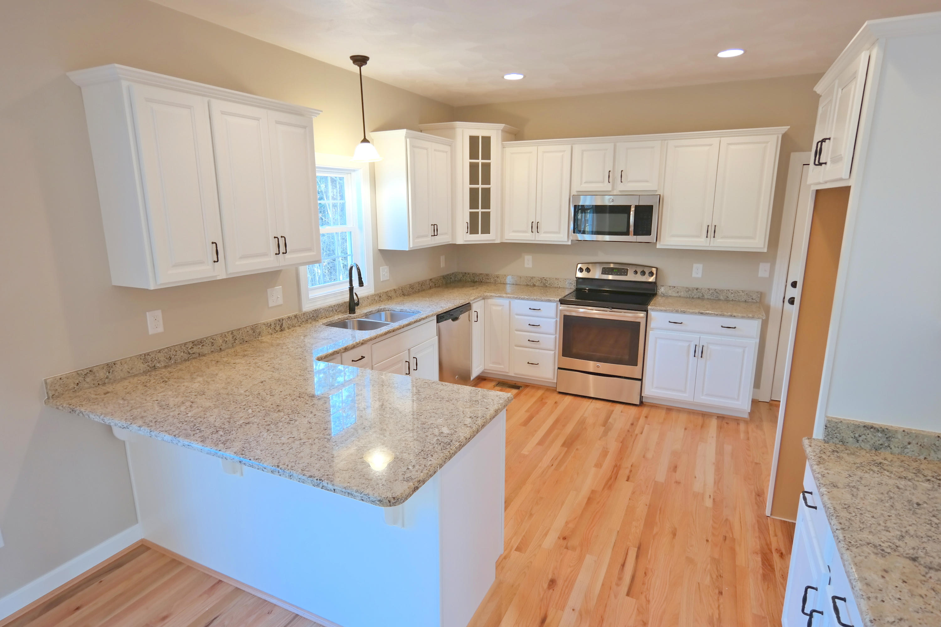 594 Thornblade Way Blue Ridge, VA 24064 - Photo 4 of 21 a kitchen with stainless steel appliances granite countertop a sink stove and refrigerator