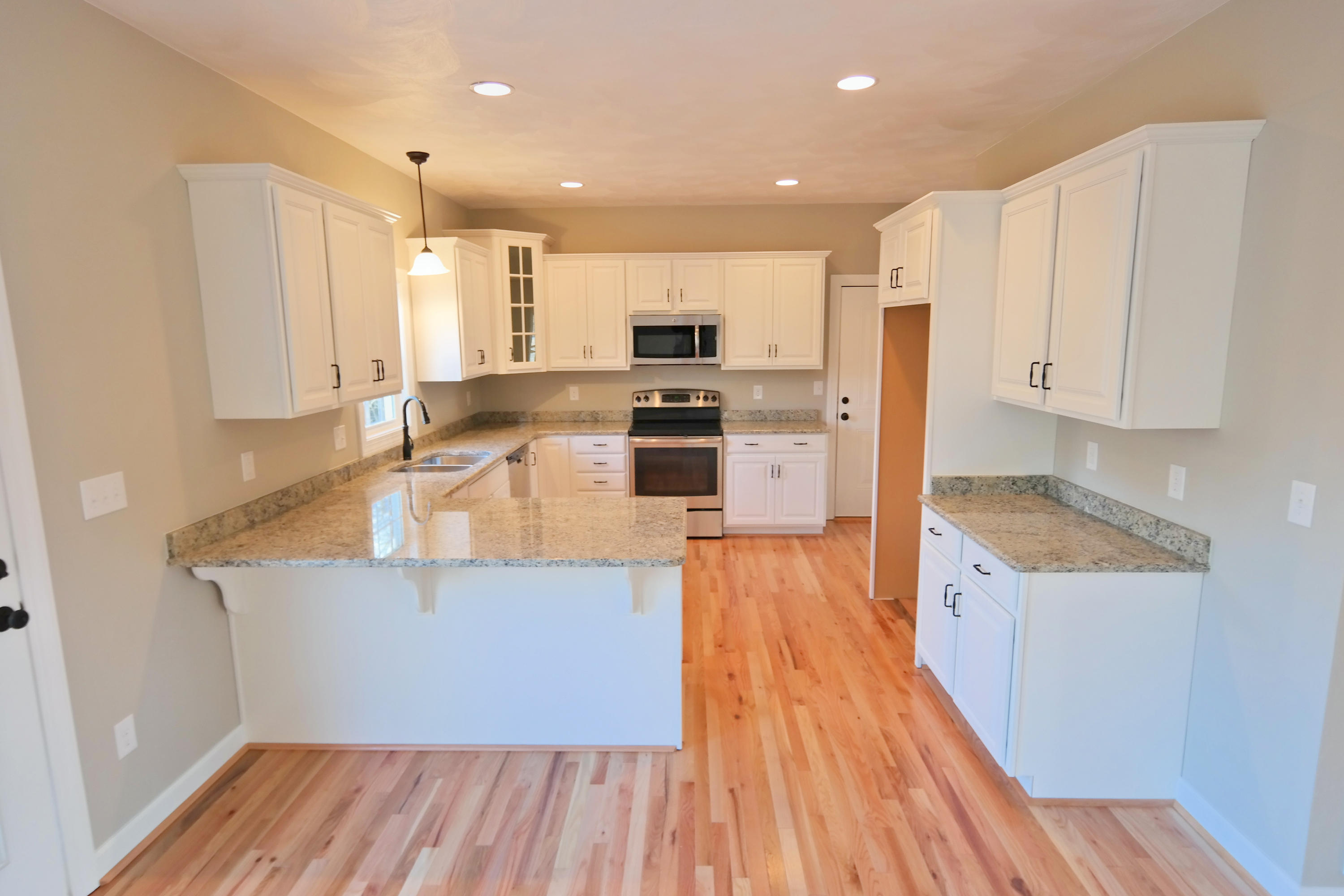 594 Thornblade Way Blue Ridge, VA 24064 - Photo 5 of 21 a kitchen with stainless steel appliances granite countertop a stove a sink and a refrigerator