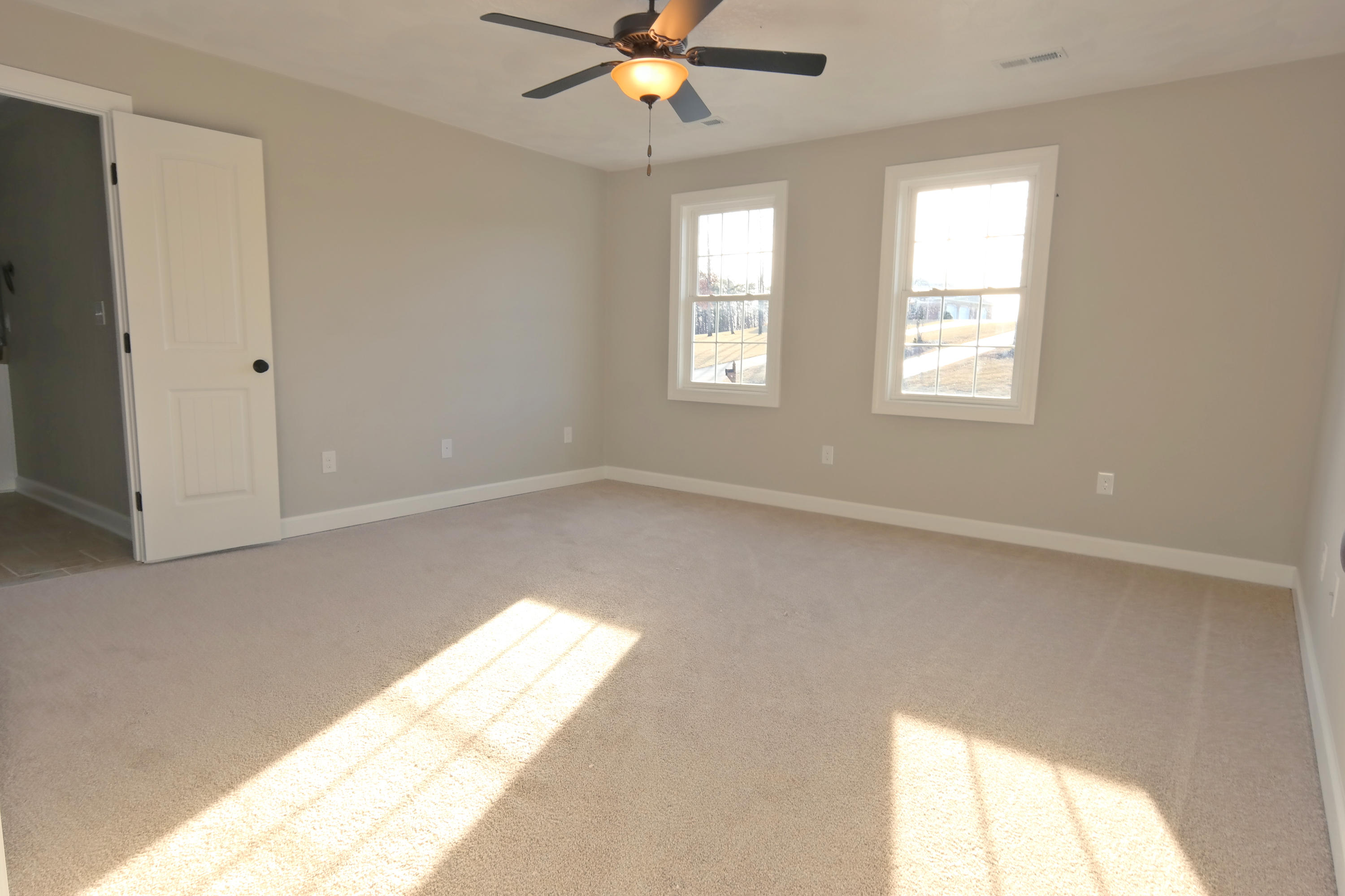 594 Thornblade Way Blue Ridge, VA 24064 - Photo 10 of 21 a view of an empty room with chandelier fan and fire place