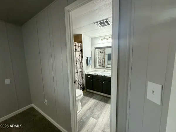 a view of hallway with wooden floor