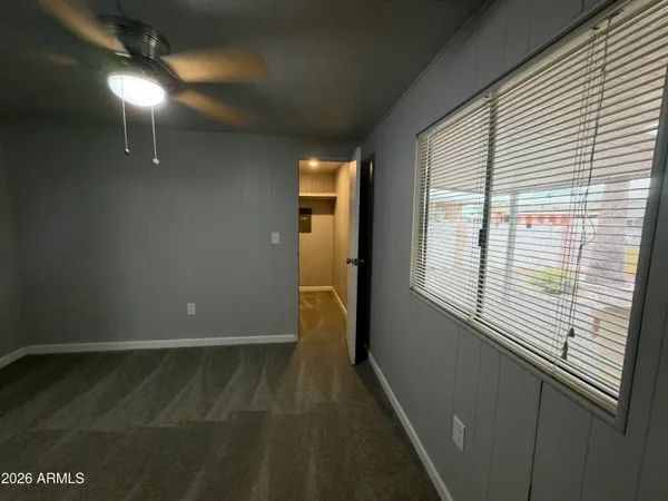 a en suite bathroom with a granite countertop sink and a mirror