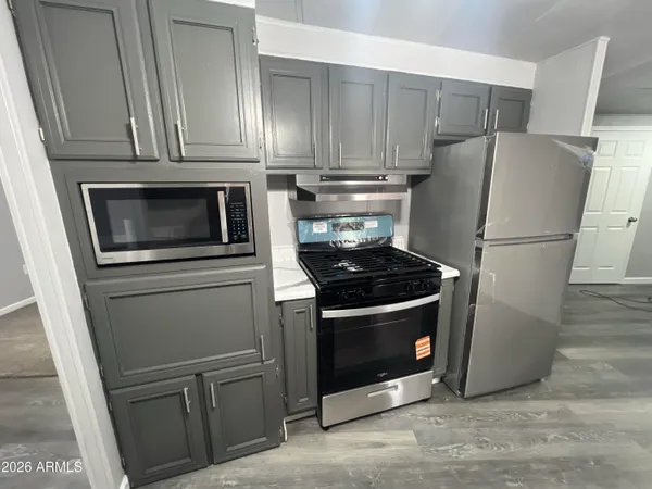 a kitchen with a stove microwave and refrigerator