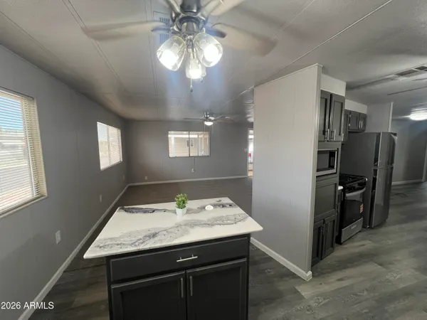 a bathroom with a granite countertop sink a shower and a mirror